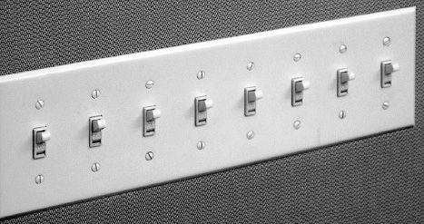 FIGURE 4.4. Incomprehensible Light Switches. Banks of switches like this are not uncommon in homes. There is no obvious mapping between the switches and the lights being controlled. I once had a similar panel in my home, although with only six switches. Even after years of living in the house, I could never remember which to use, so I simply put all the switches either up (on) or down (off). How did I solve the problem? See Figure 4.5.